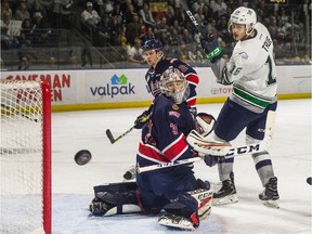 A shot by the Seattle Thunderbirds' Alexander True is deflected left of Regina Pats goalie Tyler Brown during Friday night's Game 5 of the WHL's championship series.