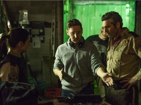 Amy Matysio (left) and Leo Fafard (right) speak with director Lowell Dean on the set of Another WolfCop.