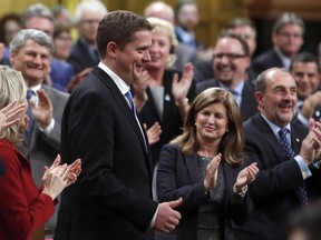 Conservative Leader Andrew Scheer receives a standing ovation from Rona Ambrose and other members of Parliament in the House of Commons during Question Period on Parliament Hill in Ottawa, Monday, May 29, 2017.