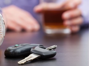 Car keys near bottle of alcohol. Photo by Getty Images.