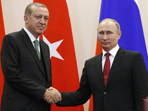 Russian President Vladimir Putin (right) and Turkish President Recep Tayyip Erdogan shake hands in Sochi on May 3.