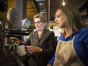 The Liberal government of Ontario Premier Kathleen Wynne (left, shown at a coffee bar in 2014), introduced several significant pieces of employment legislation this week.