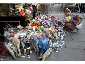 People lay flowers after a vigil in Albert Square, Manchester, England, Tuesday May 23, 2017, the day after the suicide attack at an Ariana Grande concert that left 22 people dead as it ended on Monday night.
