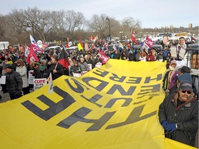 Rally participants hold a banner reading "The Cuts Stop Here" to protest government plans to lay off or roll back wages of public sector workers during a rally outside the Saskatchewan Legislative Building in Regina Wednesday, March 8, 2017.