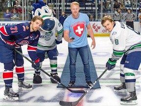 Regina-born Seattle Seahawks punter Jon Ryan performs the ceremonial faceoff before Wednesday's Game 4 of the WHL's championship series between the Regina Pats (represented by Dawson Leedahl) and Seattle Thunderbirds (Scott Eansor).