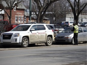 A City of Regina parking enforcement officer issues a ticket on the 1700 block of 13th Avenue.