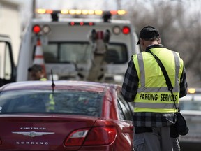 A City of Regina parking enforcement officer issues a ticket on the 1700 block of 13th Avenue in Regina.