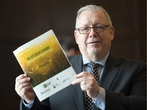 Steve McLellan, CEO of the Saskatchewan Chamber of Commerce, holds up TransformSK, a report on how to improve business and life in Saskatchewan, at the Hotel Saskatchewan in Regina on April 24, 2017.