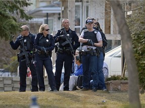 Regina Police Service prepare to approach a house on Mullen Ave.