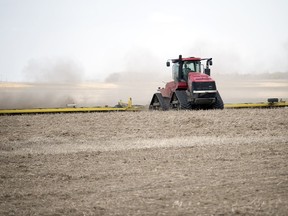 A farmer works his field approximately 10 kilometres north of Regina.