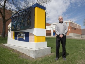 John (Jerry) Labatt stands outside O'Neill High School in Regina, where he was part of the first graduating class in 1967.