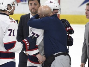 Regina Pats captain Adam Brooks, 77, hugs athletic thereapist Greg Mayer after Sunday's season-ending loss to the Seattle Thunderbirds.