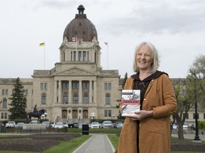 Kathleen Carlisle stands with her book Fiery Joe near the Legislative Building. The author has spent the past decade writing about Joe Phelps, a farmer who was involved in the founding of the CCF party and became a senior member of Tommy Douglas's cabinet.