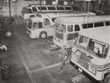 A photo of the Provincial Archives of Saskatchewan Photograph No. 77-1840-49, that says "Sask. Transportation Co. buses in the garage in Regina" taken Dec. 1977.