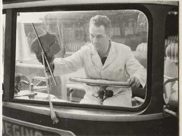 A photo of the Provincial Archives of Saskatchewan Photograph No. 58-454-05, that says "Mr. R. Rozycki using a chamois on the inside windshield of a Saskatchewan Transportation Company bus" taken Sept. 1958.