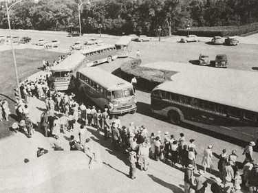 A photo of the Provincial Archives of Saskatchewan Photograph No. 55-147-03, that says "Saskatchewan Transportation Company buses, parked in front of the Legislative Building, prepare to load crowd prior to departure for the S.C.S.A. picnic at Fort Qu'Appelle, Sask." taken July 1955.