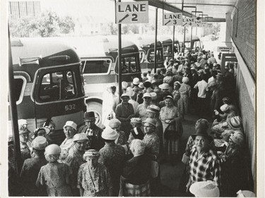 A photo of the Provincial Archives of Saskatchewan Photograph No. 61-263-01, that says "General view of group of old age pensiouners boarding Saskatchewan Transportation Company buses for departure to Katepwa for picnic" taken June 1961.