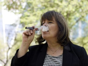Valerie Bradshaw, a local cigar smoker and aficionado, enjoys a cigar in Victoria Park in Regina.