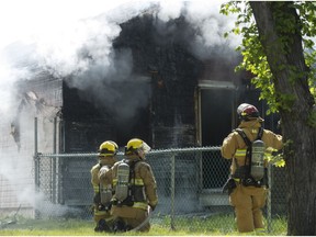 Regina Fire and Protective Services monitor a smouldering house at 755 Athol St.