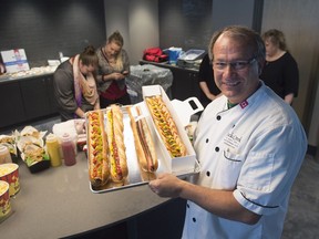 A press conference was held for the upcoming concert this Saturday at Mosaic Stadium in Regina.  Here chef Lloyd Frank prepares a 2 foot linemen hotdog on display as part of the food and beverage options going to be available.