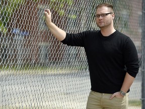 Jesse Ireland, co-chair of Queen City Pride, stands in the baseball diamond in Central Park in Regina.