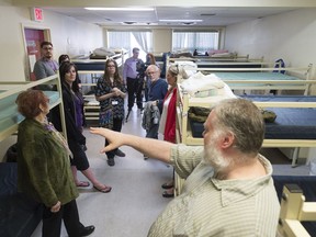 Case worker Bruce Churchill, bottom right, leads an open house tour of the Salvation Army's Waterston Centre during Mental Health Week. The centre provides basic necessities like shelter and rehab for marginalized people.