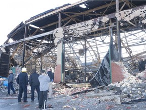 People survey the fire damage that happened Tuesday night to a section of the GMC building.