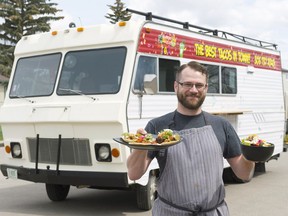 Tim Philp, owner of Nacho Fiesta food truck, holds a plate of tacos and a taco salad.