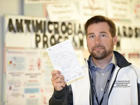 Robert Parker, manager of the RQHR's Antimicrobial Stewardship Program, holds up a "viral prescription pad" – an information sheet doctors can give patients instead of a prescription for an antibiotic.