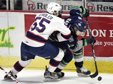 Regina Pats defenceman Liam Schioler checks Seattle Thunderbirds forward Mathew Barzal into the boards in Game 2 of the WHL championship series at the Brandt Centre on Saturday.