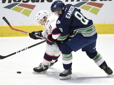 Regina Pats Nick Henry and Seattle Thunderbirds Scott Eansor fight for the loose puck in game 2 of the WHL championship series at the Brandt Centre in Regina.