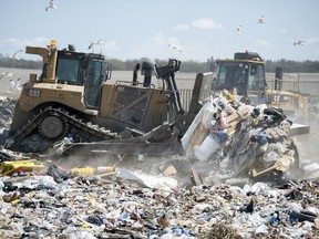 Heavy equipment moves trash around at the City of Regina Landfill in Regina.