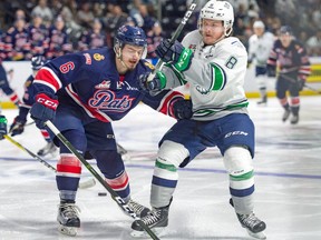 The Regina Pats' Chase Harrison battles with the Seattle Thunderbirds' Scott Eansor during Game 4 of the WHL championship series on Wednesday in Kent, Wash.