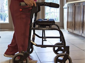 A senior uses a walker in a long-term care facility.