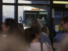 A group of people watch the last STC buses roll into the Saskatoon Bus Depot on May 31, 2017. The crowd was there to protest the winding down of STC.