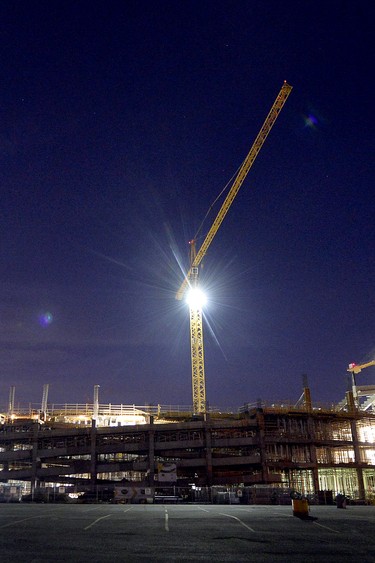 The full moon rises over the new stadium under construction at Evraz Place in Regina.