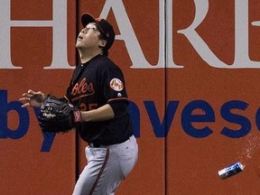Baltimore Orioles&#039; Hyun Soo Kim gets under a fly ball as a beer can sails past him during seventh inning American League wild-card game action against the Toronto Blue Jays in Toronto, Tuesday, Oct. 4, 2016. A Crown lawyer says a man who threw a beer can onto the field during a Blue Jays playoff game should be sentenced to 12 months of probation.THE CANADIAN PRESS/Mark Blinch
