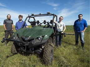 Joshua Friedrick, from left, Caleb Friedrick, Sam Dietrich and Dean Kertaiin get ready to enter their autonomous side-by-side sprayer into the upcoming agBOT competition in Rockville, Indiana.  The group is using a test farm near Pense to prepare for this years competition.