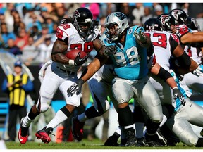 Linden Gaydosh #98 of the Carolina Panthers tries to stop Steven Jackson #39 of the Atlanta Falcons during their game at Bank of America Stadium on November 3, 2013 in Charlotte, North Carolina.