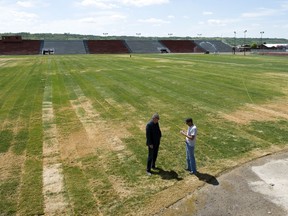 Gerry Krochak, director of marketing (left) and Ted Gross, vice-president operations, have a conversation on the planted sod in the concert bowl area of the Country Thunder Saskatchewan site in Craven.