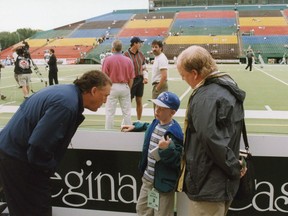 Don Matthews, left, talks with Austin Davis and his dad Darrell at Taylor Field before a 1998 game between the Toronto Argonauts and the Saskatchewan Roughriders.