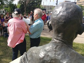 Florence Stratton (L) and Bob Hughes (R) speak in front of the Gandhi statue outside Regina city hall during a protest in support of civil disobedience. CRAIG BAIRD/LEADER-POST