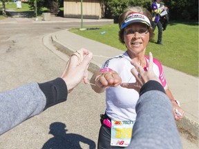 Thea Jacobs gets another rubber band, indicating another lap around Wascana Lake, during the Marathon Matters fun run on Saturday.