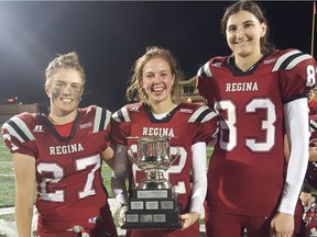 Left to right: Emilie Belanger, Payton Kuster and Jennilea Coppola with the championship trophy after the Regina Riot defeated the Calgary Rage 53-0 in the Western Women's Canadian Football League's championship game Saturday in Saskatoon.