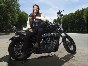 Tanya Kleemola sits on her Harley-Davidson near the spot where she suffered a serious accident in June 2016.