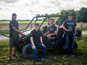 The Prairie Robotics team (from left) Joshua Friedrick, Sam Dietrich, Caleb Friedrick and Dean Kertai pose with their crop-spraying robot and their first-place award from the 2017 AgBot Challenge in Rockville, Ind.