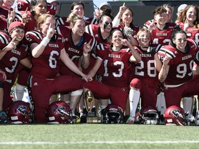 Regina Riot players celebrate after winning the Western Women's Canadian Football League's Western Conference title Sunday at Taylor Field.