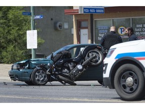 REGINA, SASK : June 7, 2017 - Regina Police Service members attend to an accident between a car and a motorcycle at the corner of Donald St. and Dewdney Ave. MICHAEL BELL / Regina Leader-Post.