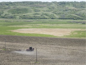 A tractor works a field in the Qu'Appelle Valley north of Regina off Highway 6 on Thursday.