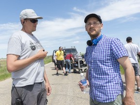 First assistant director Jason Bohn, left, and director Lowell Dean plan how to shoot a scene on the set of SuperGrid, north of Regina.